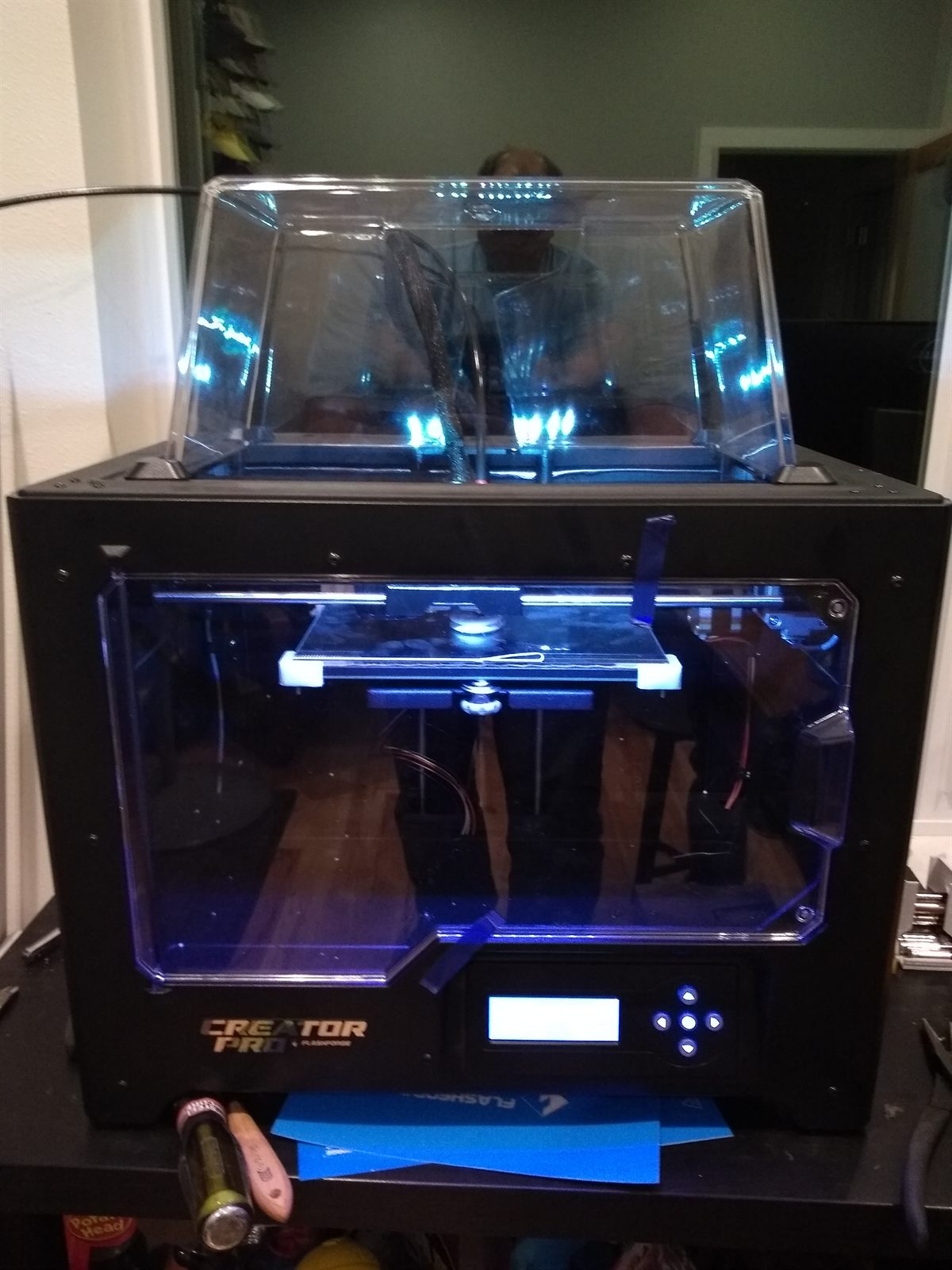 FlashForge Creator Pro printer with its acrylic enclosure and blue interior lighting