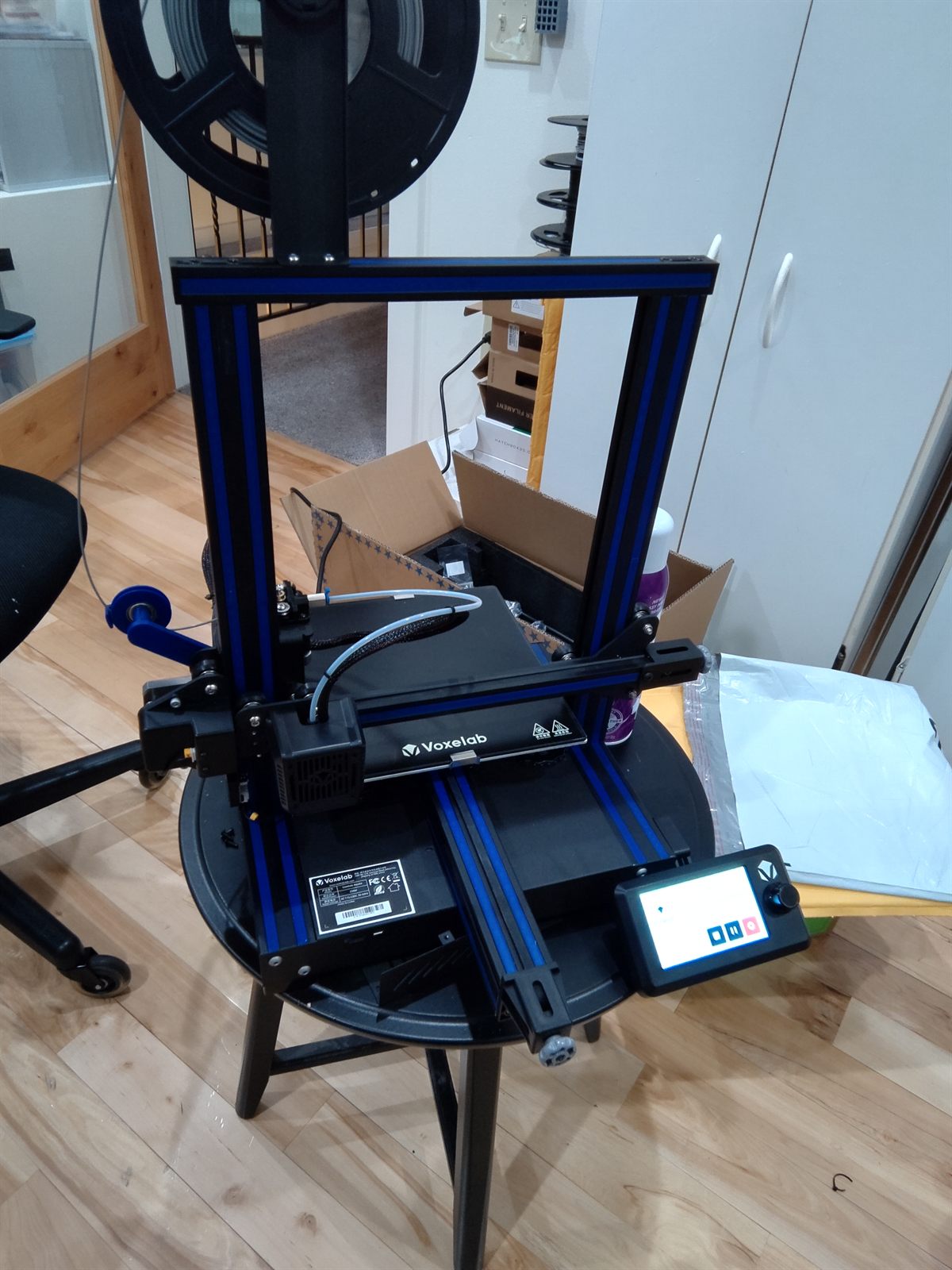 A Voxelab Aquila 3D printer being unboxed and set up