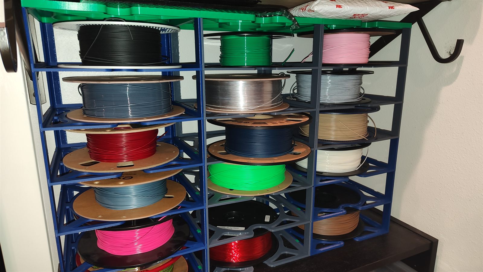 A printed filament rack holding dozens of spools of various colors