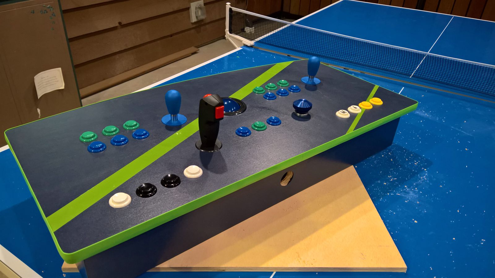Painted control panel with buttons and joysticks dry-fitted in place