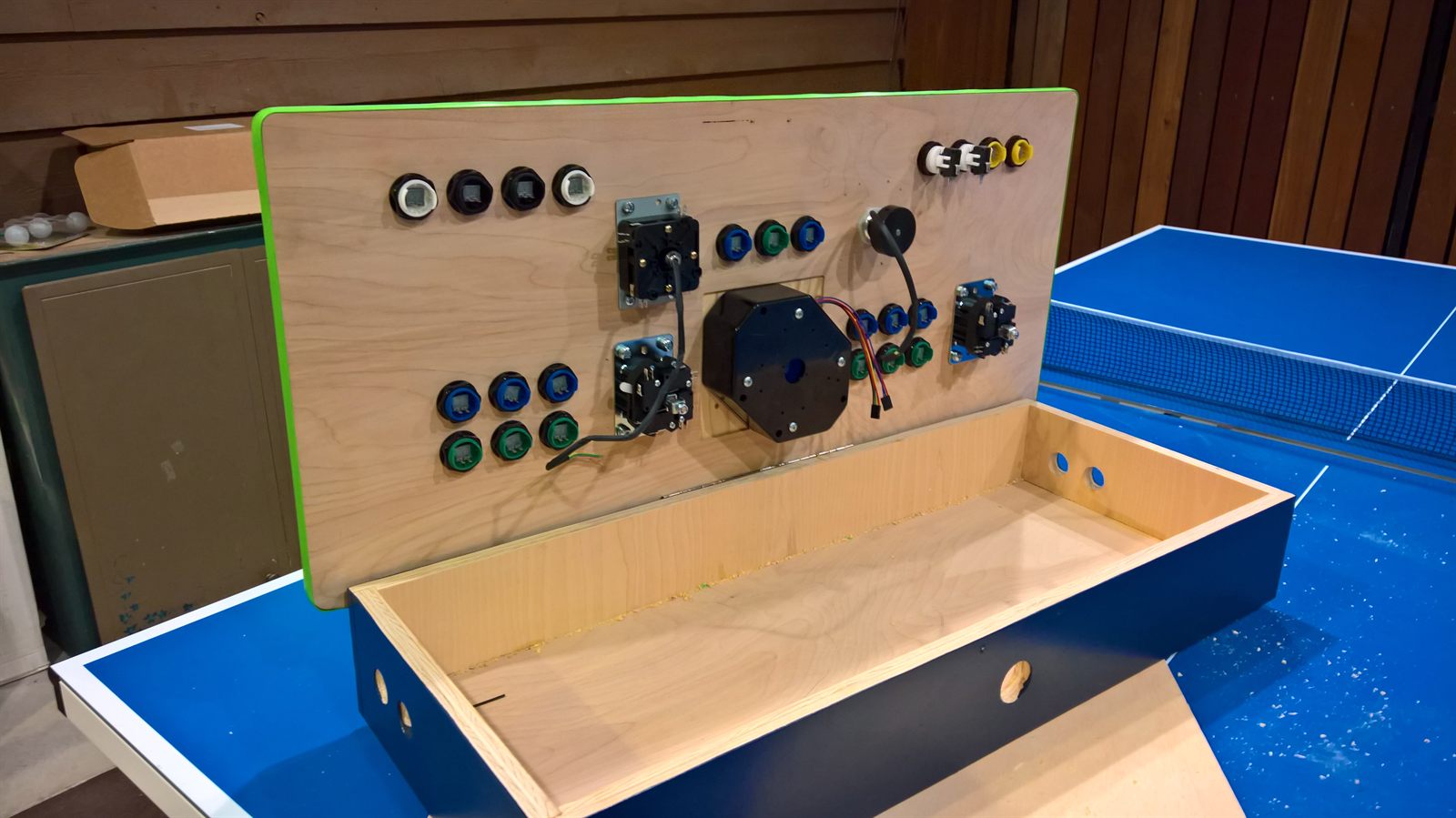 Underside of the panel showing button mounts and the empty plywood box