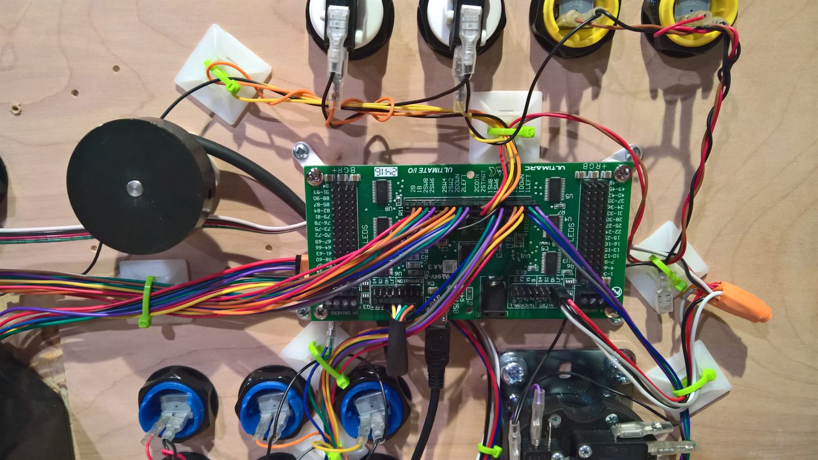 Close-up of the Ultimarc I-PAC Ultimate I/O board with screw terminals wired up