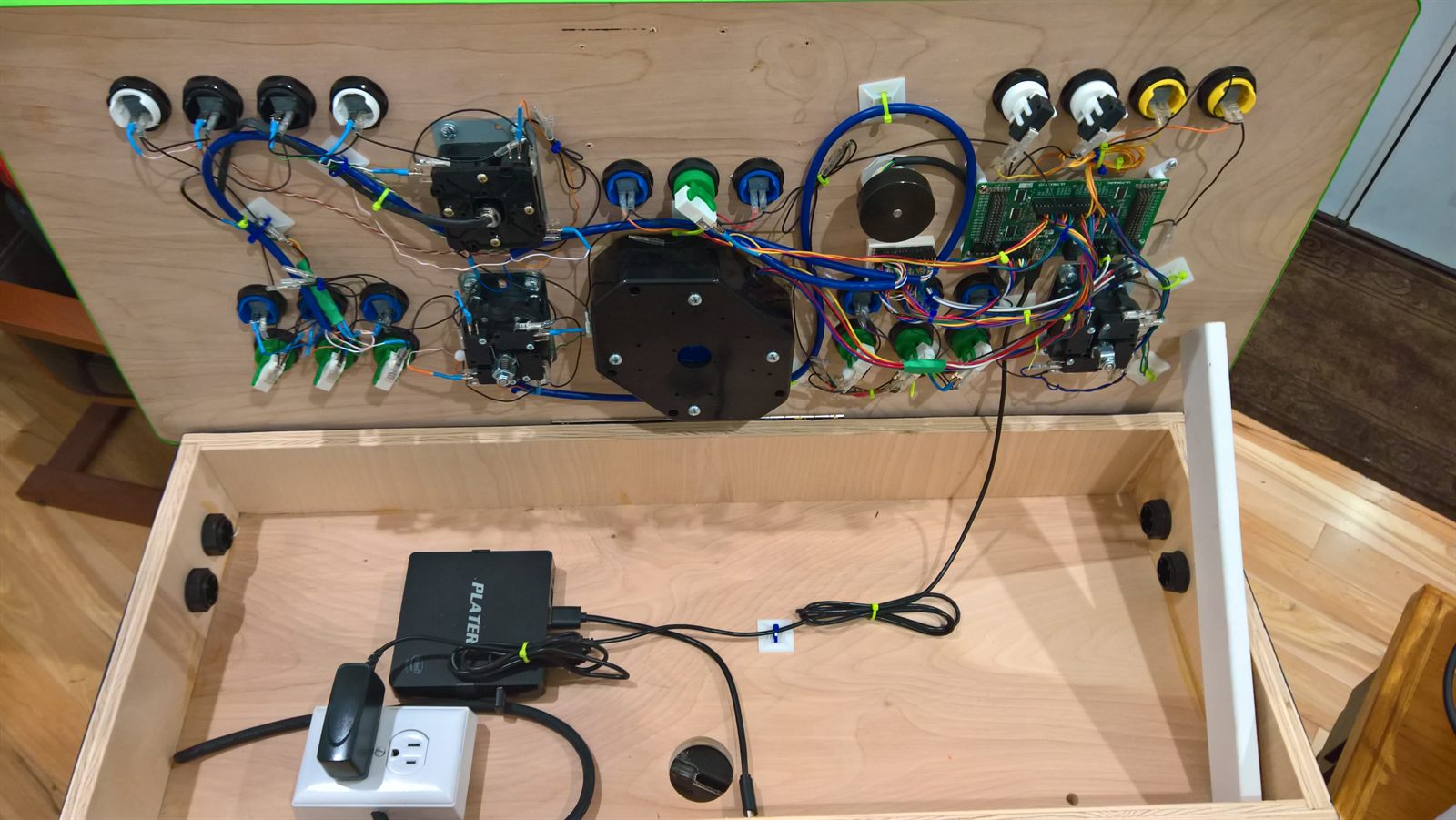 Cabinet open with wired panel and PC starting to land in the box