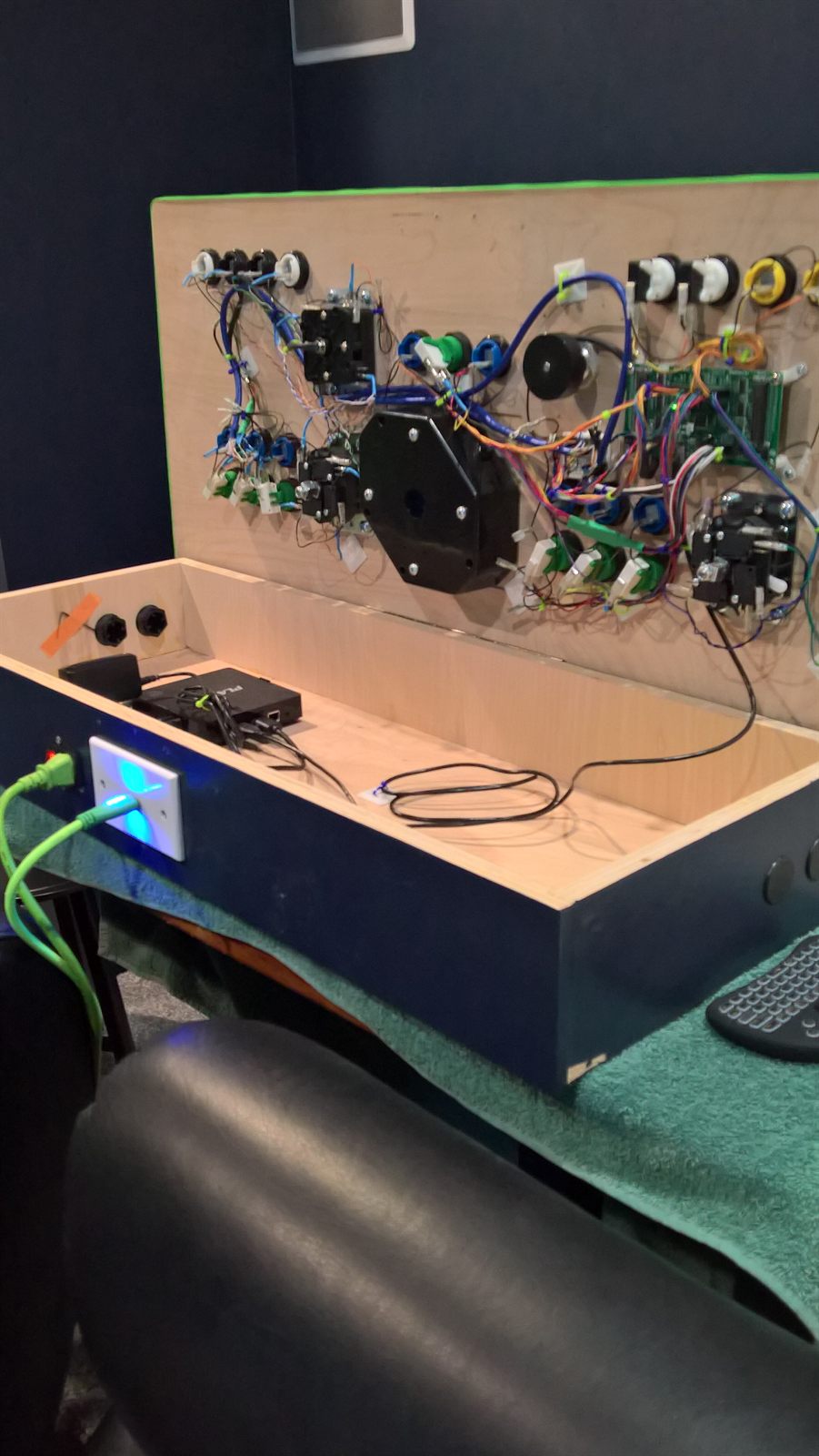 Cabinet on its side, showing the back panel power inlet, lit switch, and ports