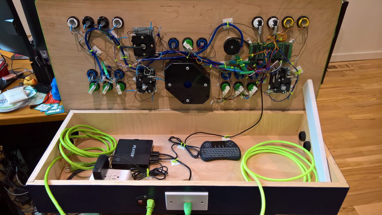 Cabinet open with coiled HDMI and keyboard stored inside