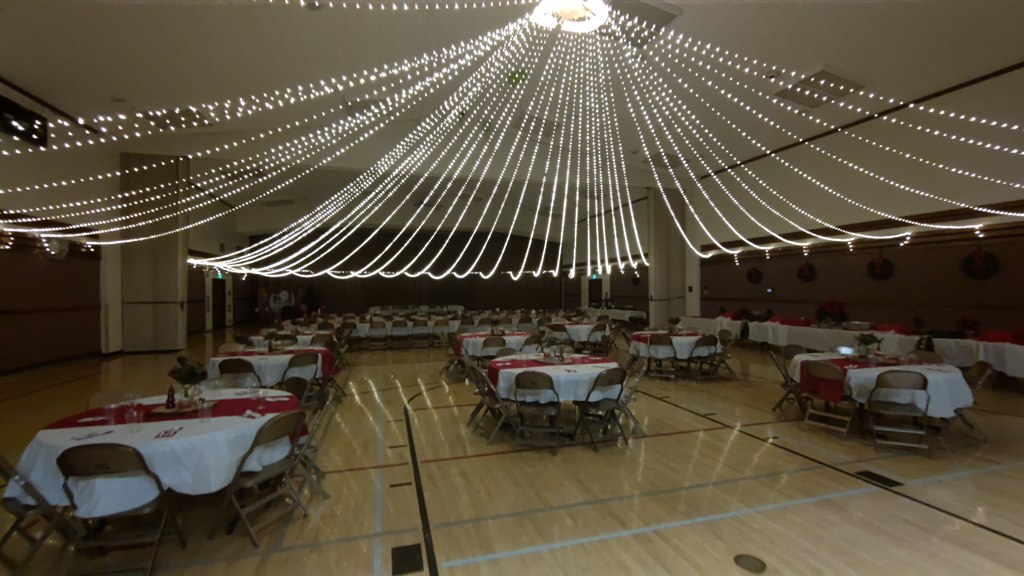 Completed cultural hall lighting rig glowing overhead