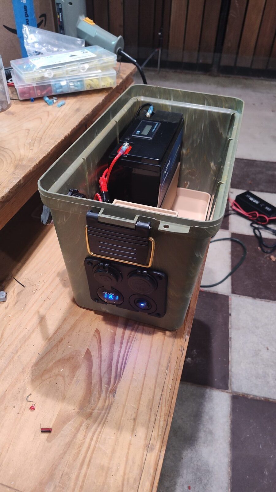 Open battery box showing the battery and internal wiring