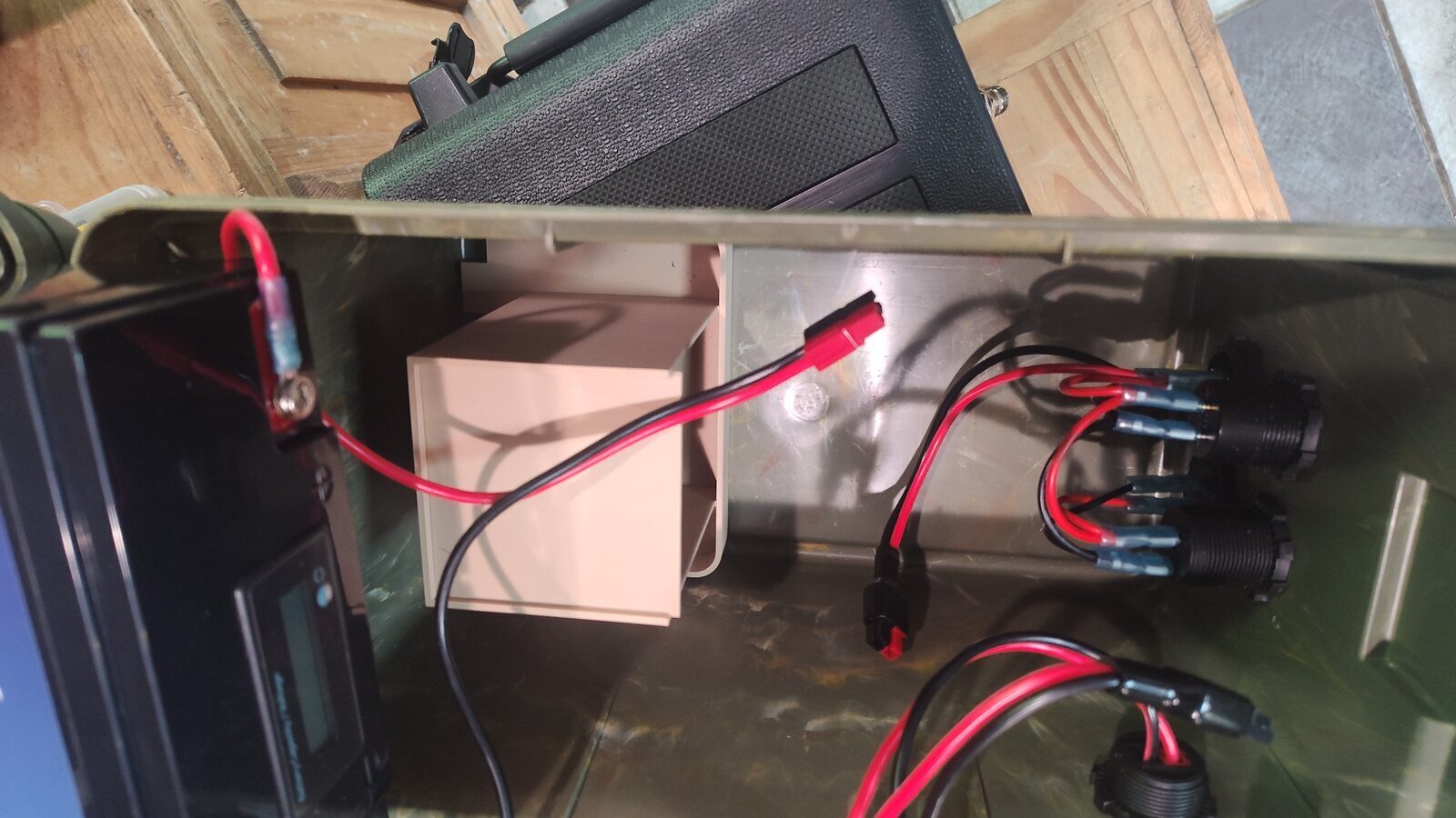 Battery box wiring routed around the battery
