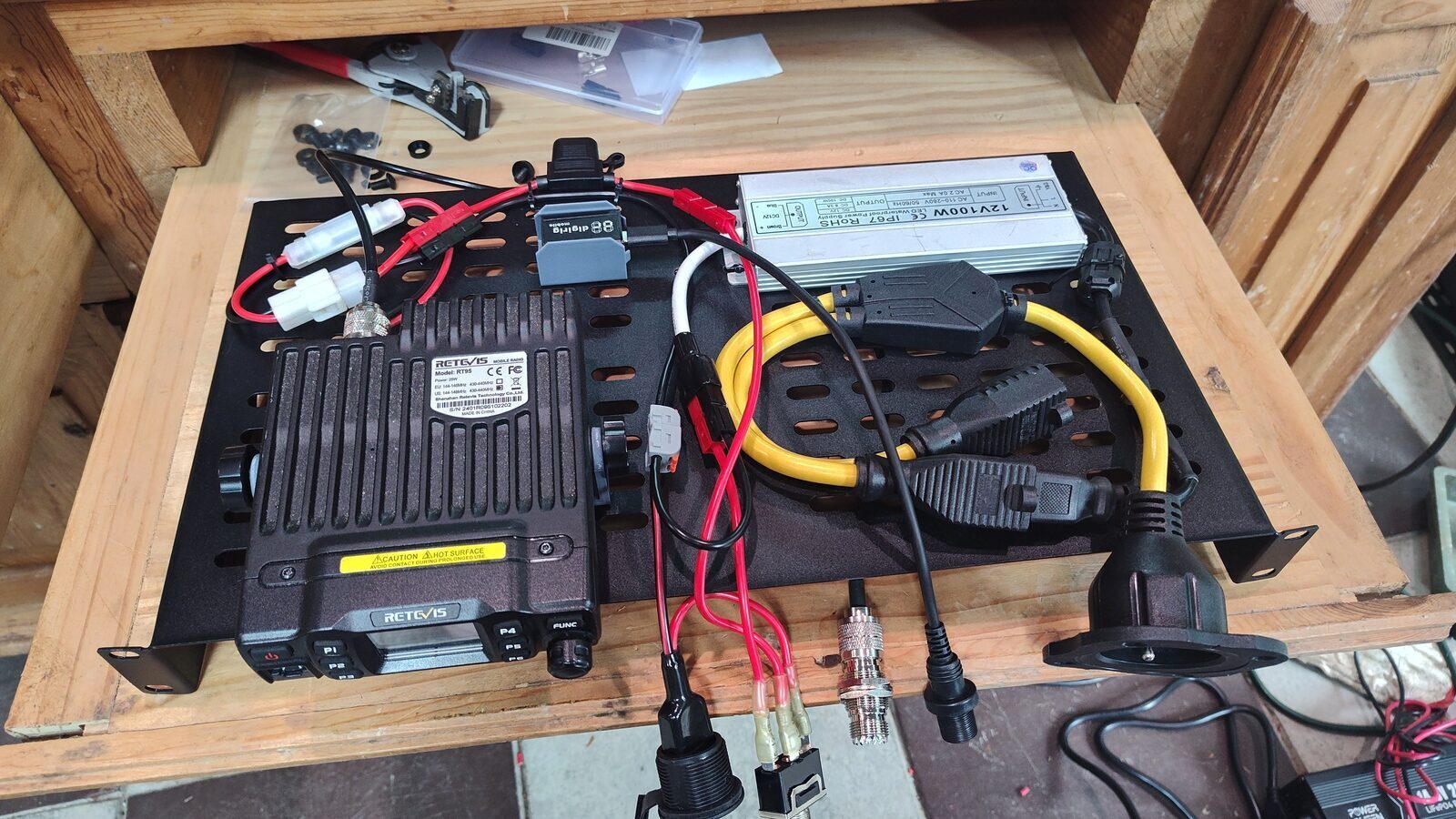 Initial layout of the power supply, radio bracket, and DigiRig holder on the shelf